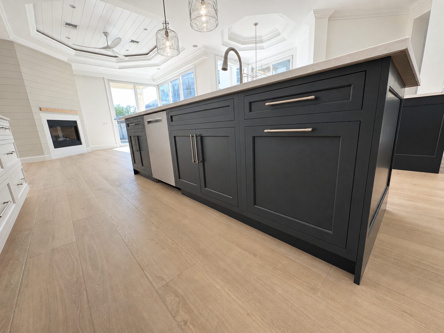 Dramatic dark luxury great room with custom island and finish carpentry