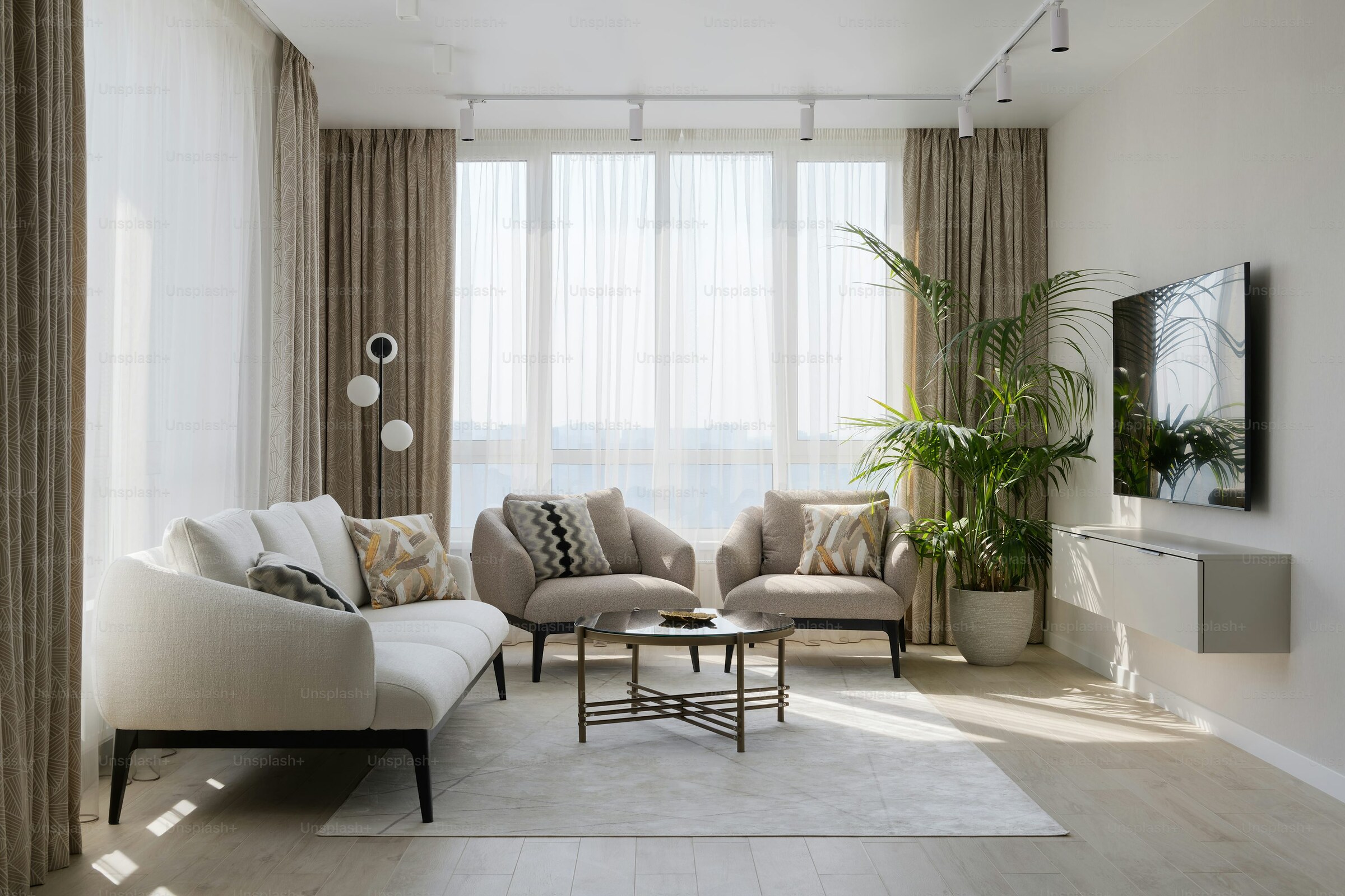 Floor-to-ceiling windows flooding a luxury living space with warm natural light